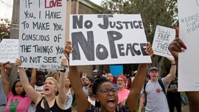 Police and protesters demonstrate in a residential neighbourhood in Baton Rouge, La. on Sunday, July 10, 2016.