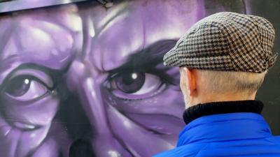 Paul lewis looking at Graffiti