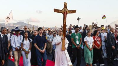 Pope Leo XIV holding up a cross