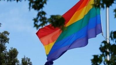 Rainbow flag flies at half mast