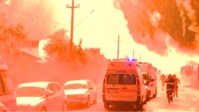 People running away from explosion lighting up the sky in Romania