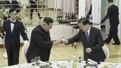 Kim Jong-un and a South Korean official raise a toast over dinner