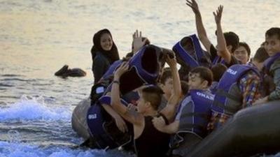 Afghan migrants rejoice on reaching the Greek island of Kos from Turkey by boat, on 9 August 2015