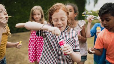 children-blowing-bubbles-in-hexham.