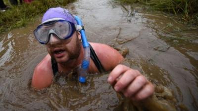 A competitor takes part in the 30th World Bog Snorkelling Championships in Waen Rhydd peat bog at Llanwrtyd Wells, south Wales on August 30, 2015. Entrants must negotiate two lengths of a 60-yard trench through the peat bog in the quickest possible time without using any conventional swimming strokes.