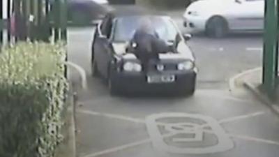 Teacher lifted onto bonnet of moving car