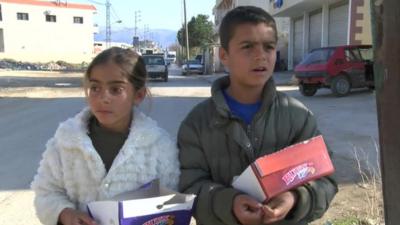 Batoul and Mohamed selling chocolate.