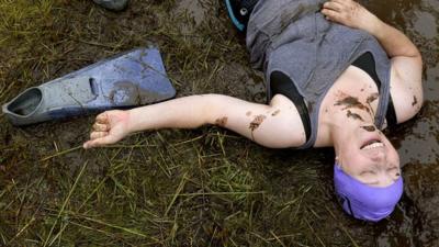 A competitor takes a breather after taking part in the 30th World Bog Snorkelling Championships