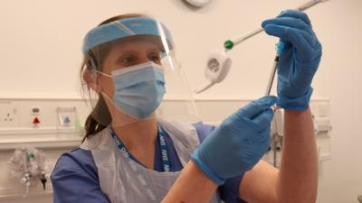 Vaccinator Victoria Simpson prepares a dose of the Covid-19 vaccine