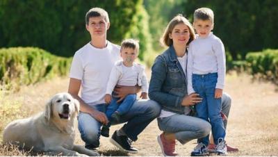 Yuliia and her sons and husband