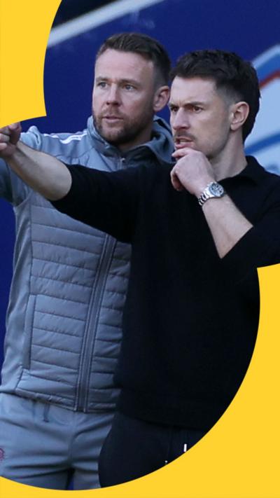 Chris Gunter (L) and Aaron Ramsey talk tactics