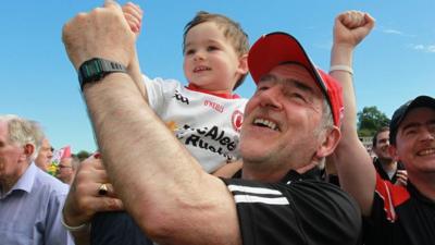 Mickey Harte celebrates with his grandson Michael at the final whistle of the 2016 Ulster Final