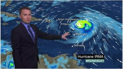 Matt Taylor standing in front of weather map of Hurricane Irma.