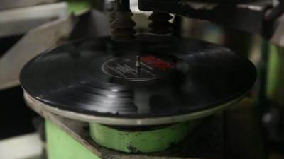 ac/dc vinyl record being stickered in machine