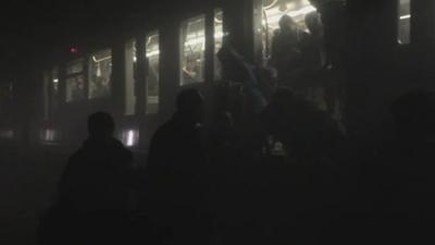 People evacuating a metro train