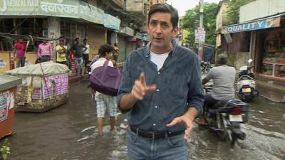 Justin Rowlatt in a flooded street