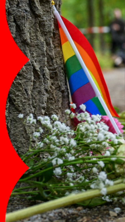 A pride flag and flowers