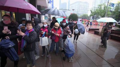 Customers queue at pharmacy