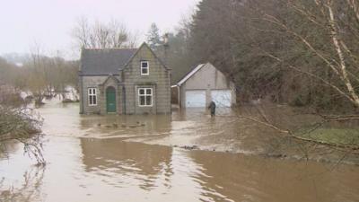 House surrounded by flood water