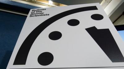 A sign showing the "Doomsday Clock" that remains at three minutes to midnight is seen after it was unveiled by the Bulletin of the Atomic Scientists, Tuesday, Jan. 26, 2016.
