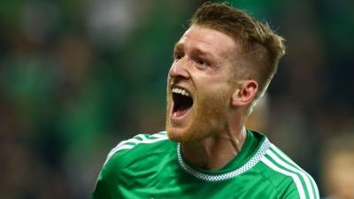 Northern Ireland captain Steven Davis celebrates scoring against Greece at Windsor Park