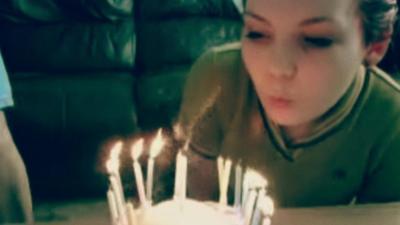 Sarah Green blowing out candles
