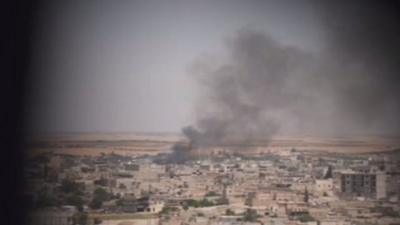 Smoke clouds hanging over the IS-held northern Syrian town of Manbij