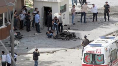 Security and forensic officials investigate the scene of the explosion