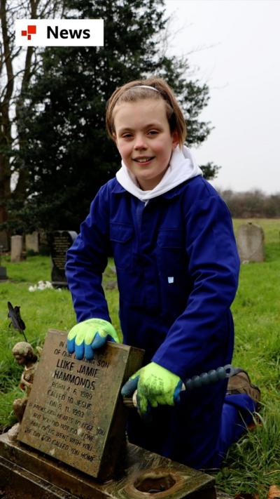 A boy, Ben, stands in a graveyard next to a headstone