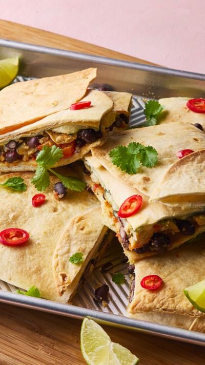 Close up shot of the breakfast quesadilla traybake on a silver baking tray