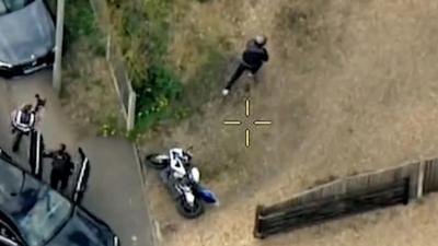 Aerial view of police chasing a motorcyclist