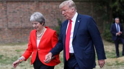 Donald Trump and Theresa May holding hands