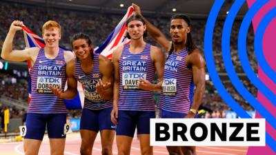 GB celebrates winning bronze while holding a Union Jack flag at the World Athletics Championships