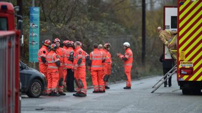 Firemen outside explosion scene