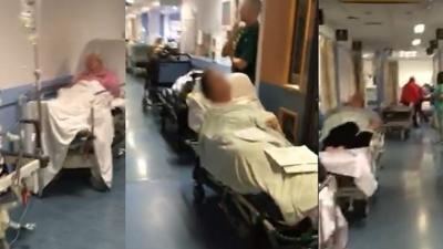 Patients waiting in corridors on trolley beds