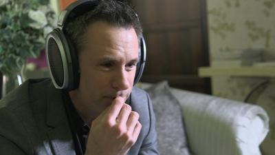 Spencer Kelly wearing Sennheiser HE-1 headphones