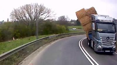 Hay bales toppling off the lorry