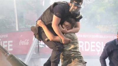 police officer pulls soldier from tank