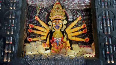 Plastic bottles are seen around a Goddess Durga wearing a mask to beat the pollution, Kolkata, India, 02 October, 2019