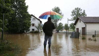 A resident in flooded streets of Triftern, Bavaria region, Germany