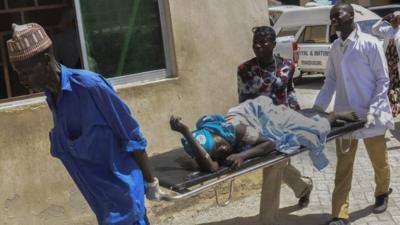 Maiduguri blast injured woman is carried on a stretcher