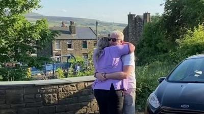 Carer hugs partner