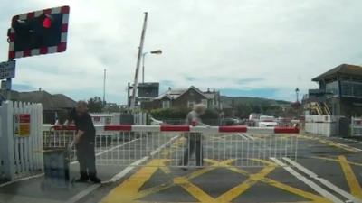Woman rescued on level crossing