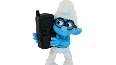 Smurf toy holding mobile phone