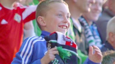 A young fan shows his support for Northern Ireland