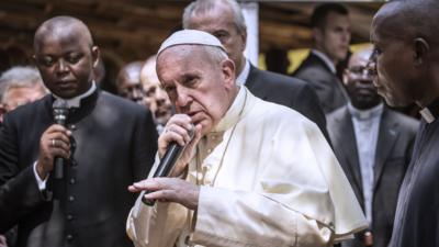 Pope Francis talking into microphone