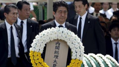 Japanese Prime Minister Shinzo Abe offers a flower wreath for the victims of the 1945 atomic bombing at Nagasaki's Peace Park in Nagasaki - 9 August 2015