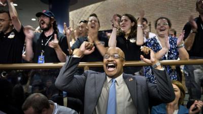 People celebrate at mission headquarters