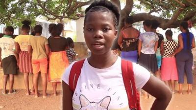 Mabinty standing in front of a group of girls