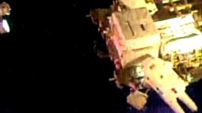 Astronauts embark on first spacewalk